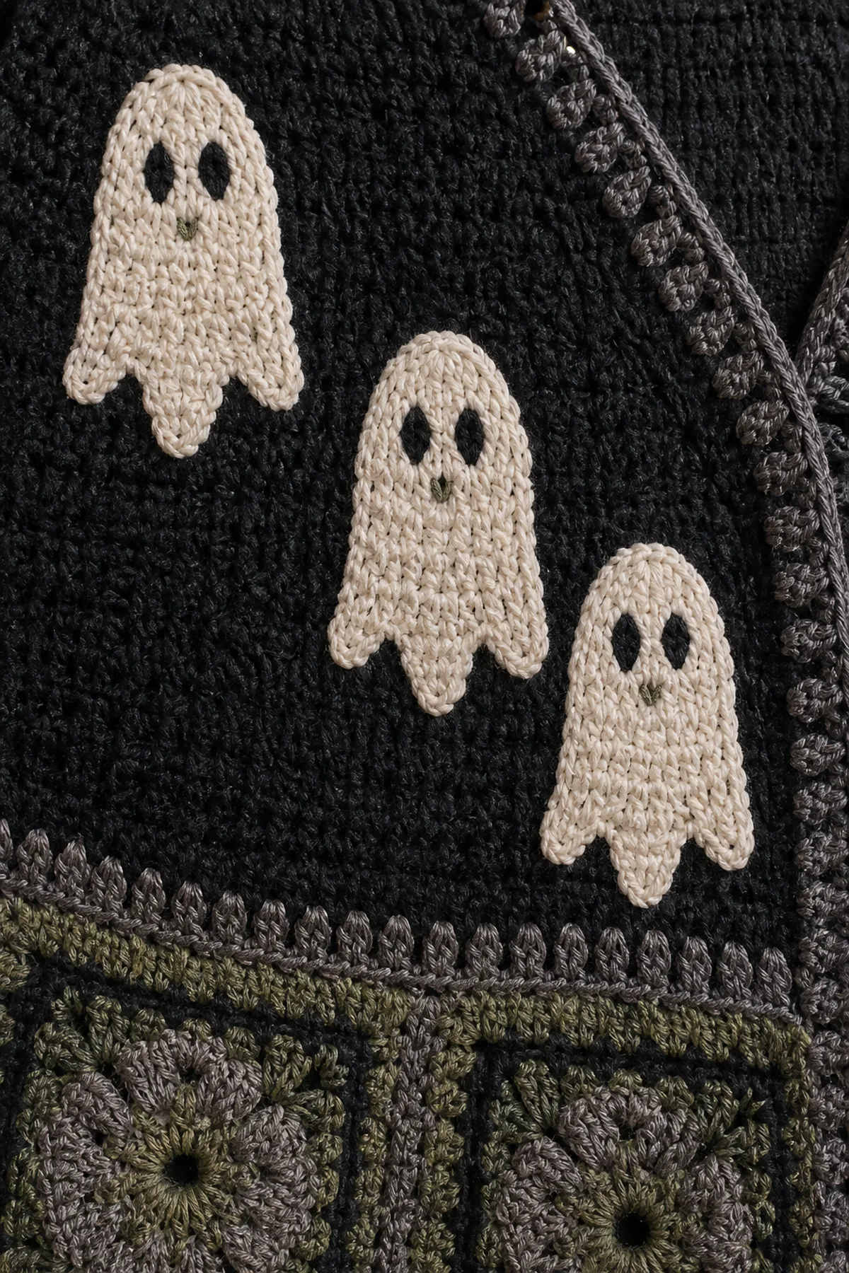 soft ivory crochet ghost applique with charcoal embroidered eyes and a tiny sage mouth
